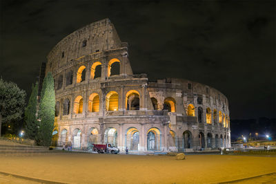 Coliseum against sky in city at night