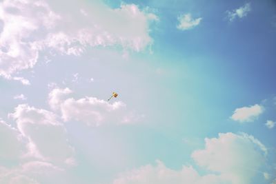 Low angle view of kite flying against sky