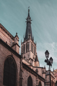 Low angle view of church and building against sky