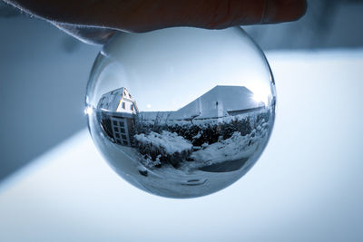 Close-up of hand on glass