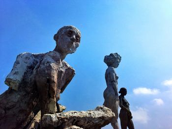 Low angle view of statue against blue sky