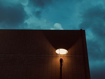 Low angle view of illuminated light against building