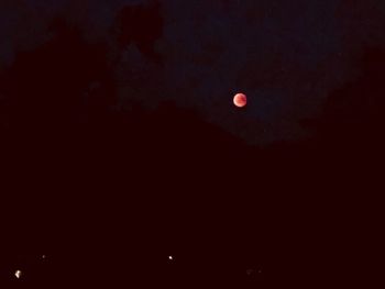 Low angle view of moon against sky at night