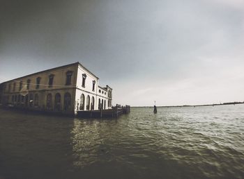 Scenic view of sea by building against sky