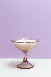 Close-up of glass on table against white background
