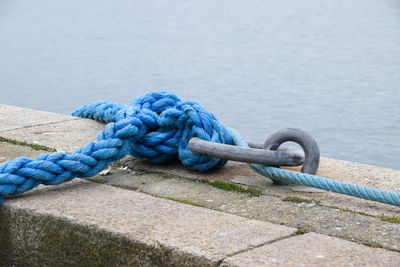 Close-up of rope tied at pier