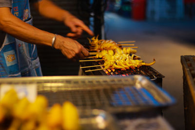 Man preparing food on barbecue grill