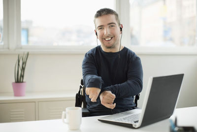 Portrait of young man using mobile phone