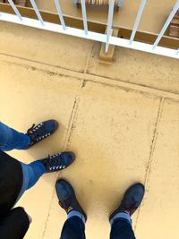 Low section of man standing on tiled floor