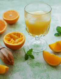 Glass of fresh orange juice with fresh fruits