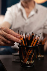 Midsection of man working on table