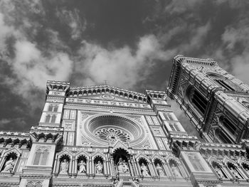 Low angle view of building against cloudy sky