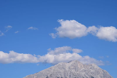 Low angle view of mountain against blue sky