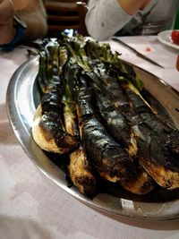 Close-up of hand in plate on table