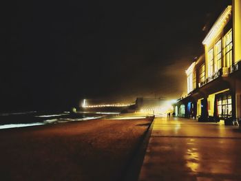 Surface level of illuminated buildings against sky at night