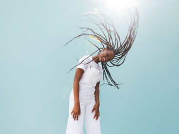 Rear view of woman standing against clear sky