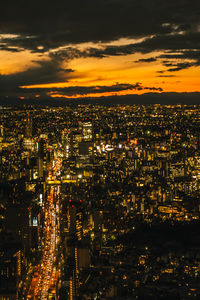 High angle view of illuminated cityscape against sky at night