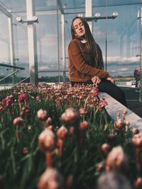 Woman with flowers in greenhouse