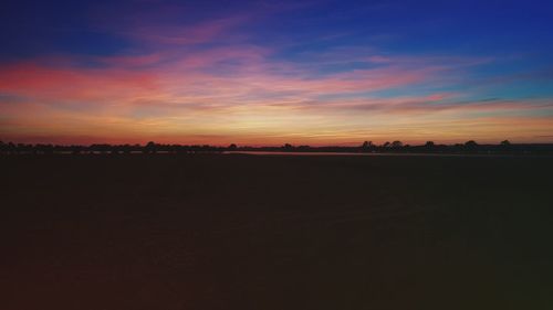 Scenic view of landscape against sky at sunset