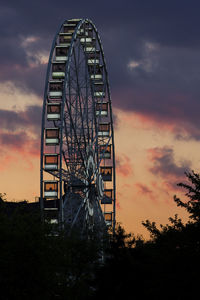 Low angle view of ferris wheel against sky