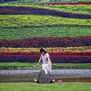 Rear view of woman standing on field