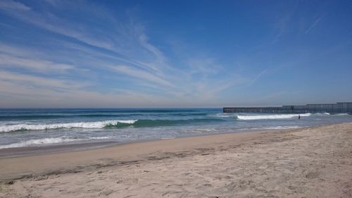 Scenic view of beach against blue sky