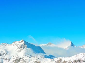 Low angle view of mountains against clear blue sky