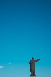 Low angle view of statue against clear blue sky