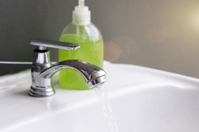 Close-up of water faucet in bathroom at home