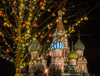 Low angle view of illuminated christmas lights at night