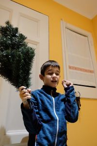Boy holding baby at home