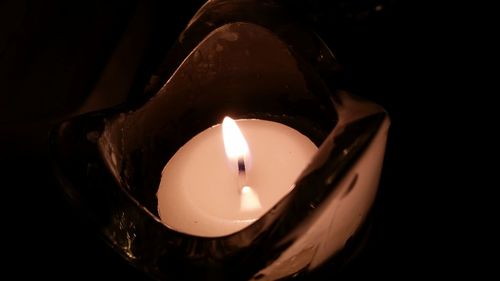 Close-up of illuminated lamp in darkroom