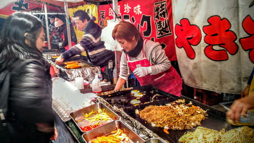 People for sale at market stall