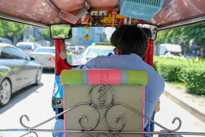 Rear view of man sitting in car