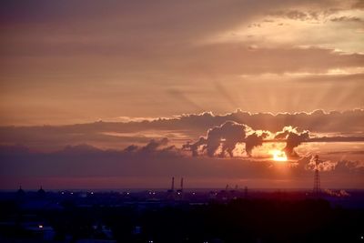 Silhouette buildings against sky during sunset