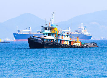 Ship sailing on sea against sky