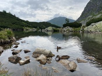 Scenic view of lake and mountains against sky