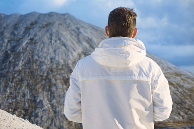 Rear view of man looking at mountains