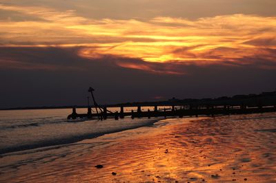 Scenic view of beach against sky during sunset