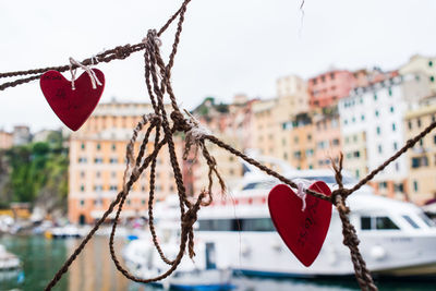 Close-up of heart shape hanging on tree against sky