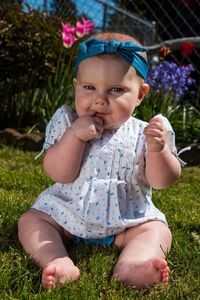 Portrait of cute girl sitting on lawn