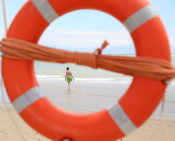 People on beach by sea against sky