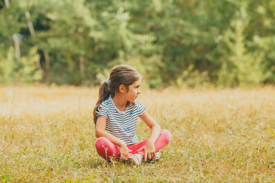 Girl sitting on field