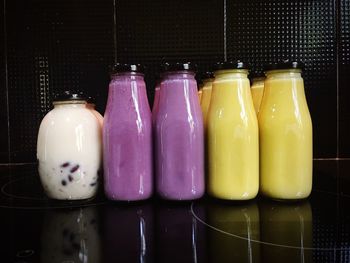 Close-up of bottles in glass jar on table