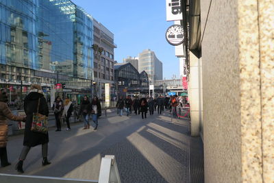 People walking on road in city