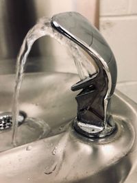 Close-up of water from faucet in bathroom