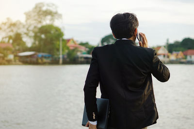 Rear view of man standing in city