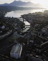 High angle view of buildings by sea against sky