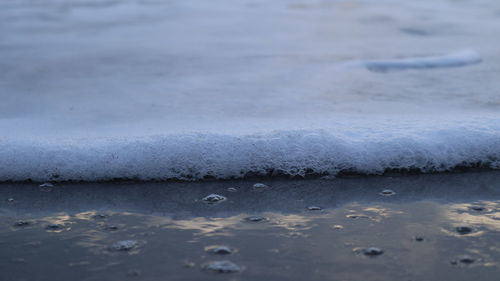 Close-up of wet frozen sea during rainy season