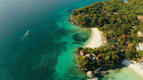 White sandy beach with tourists and hotels in boracay island.seascape with beach on tropical island.